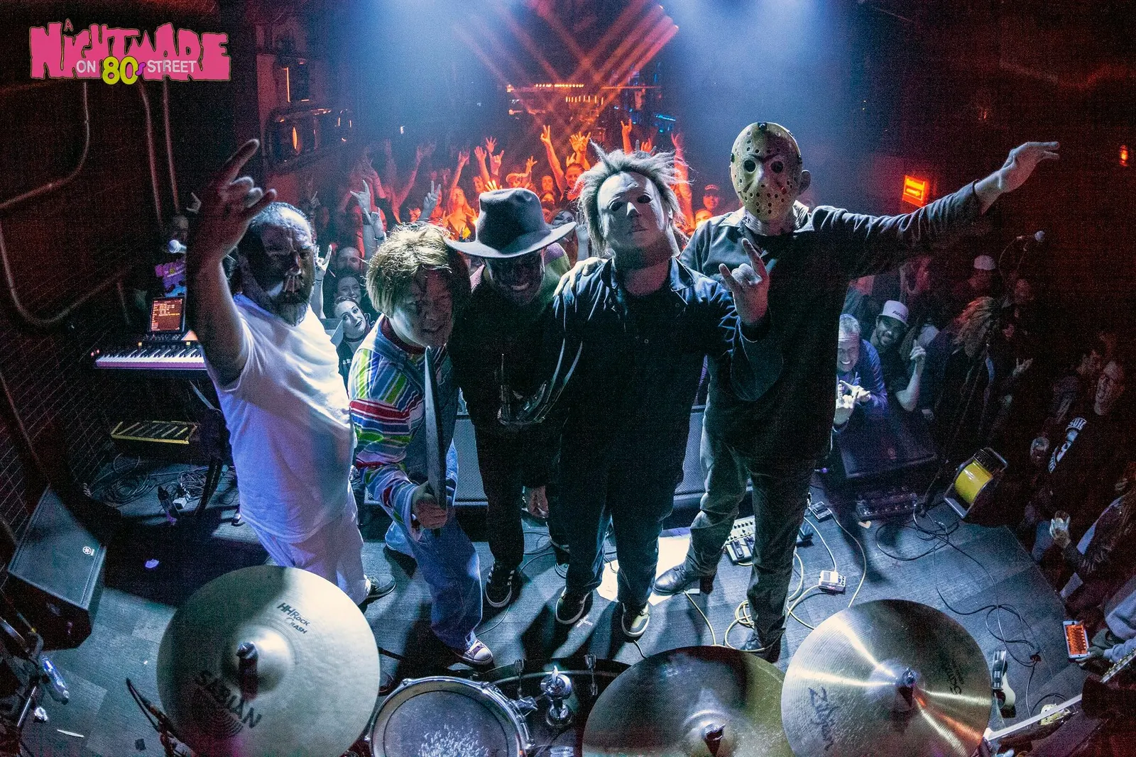 A Nightmare on 80s Street posing onstage with a packed crowd after a live performance